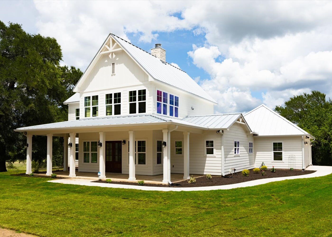 Cedar Elm custom farmhouse home exterior with wrap-around porch by RBCS Inc in North Texas