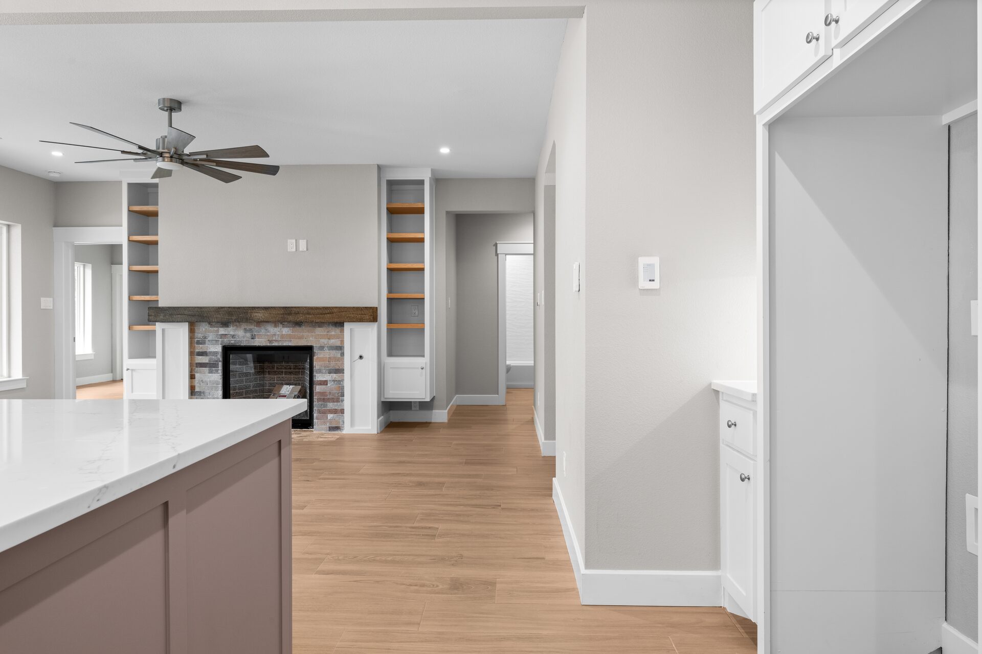 Post Oak custom home living room with fireplace and built-in shelves by RBCS Inc in North Texas