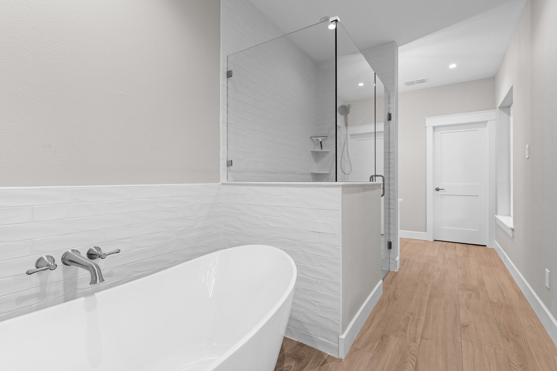 Post Oak custom home master bath with soaking tub and walk-in shower by RBCS Inc in North Texas