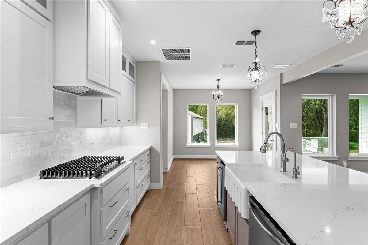 Post Oak custom home open concept kitchen with quartz island by RBCS Inc in North Texas