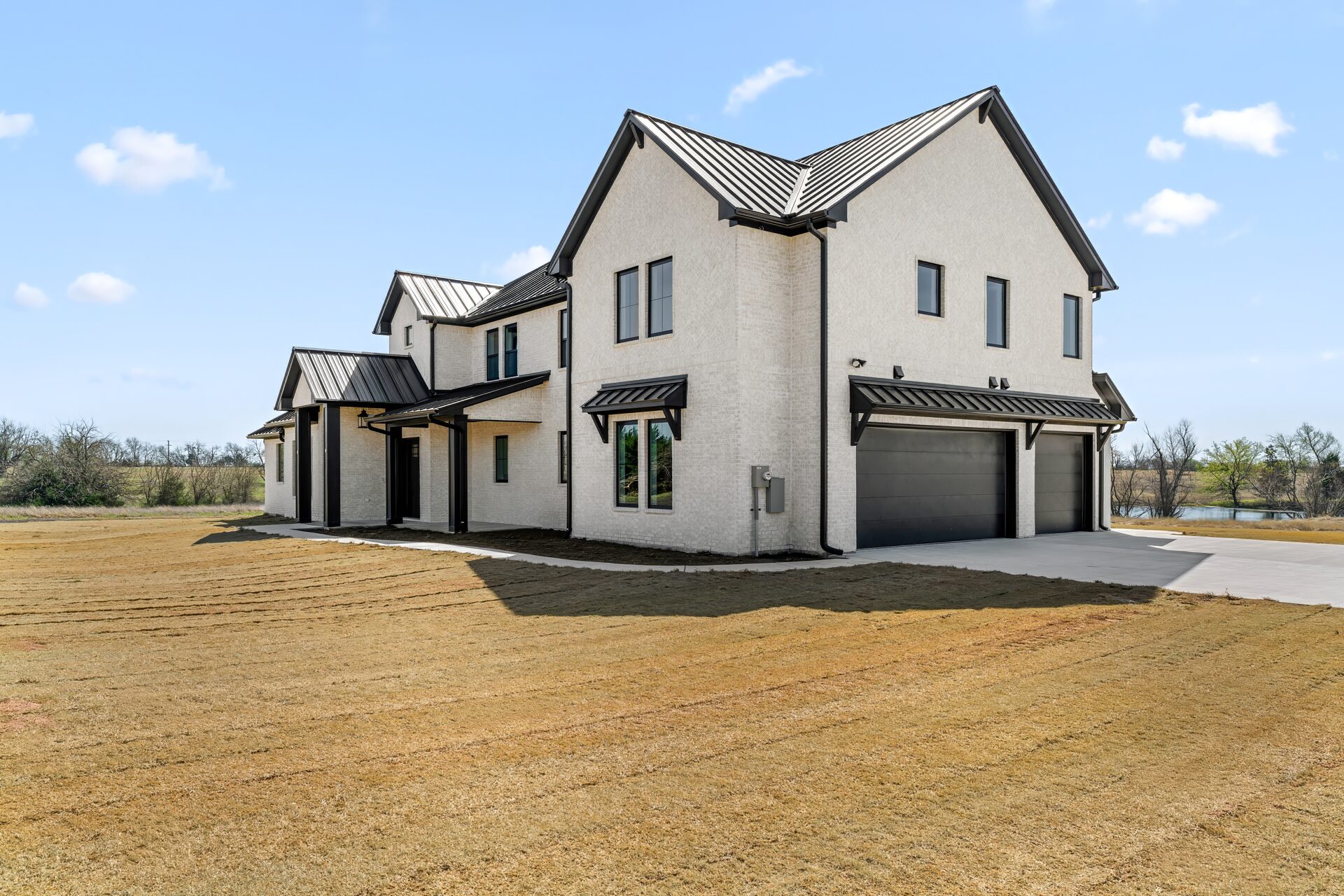 Silverado energy-efficient custom home exterior with modern European design and metal roof by RBCS Inc in North Texas