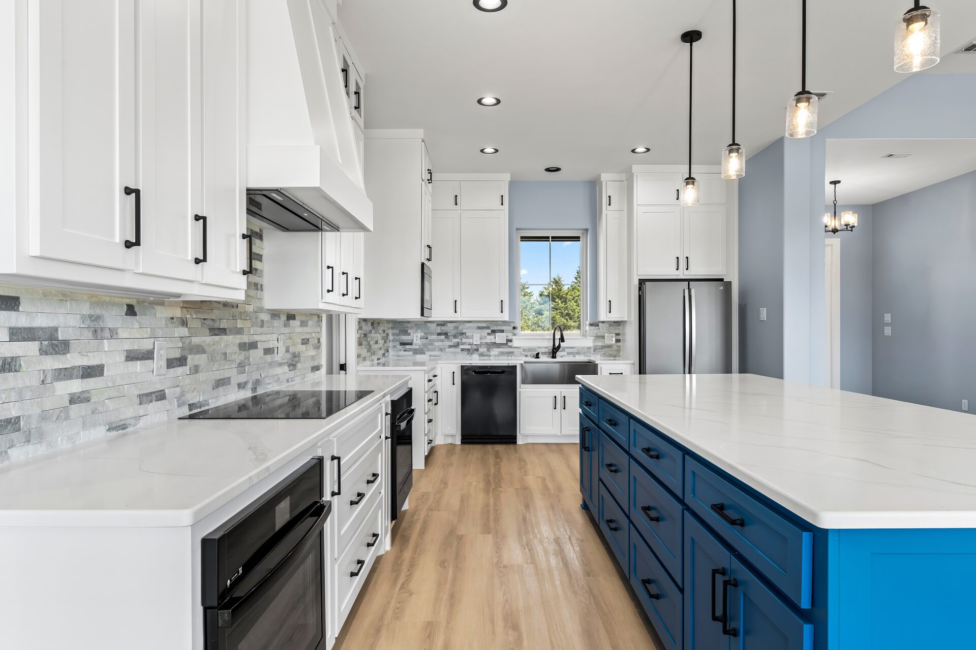 Silverado custom home kitchen with blue island and stone backsplash by RBCS Inc in North Texas