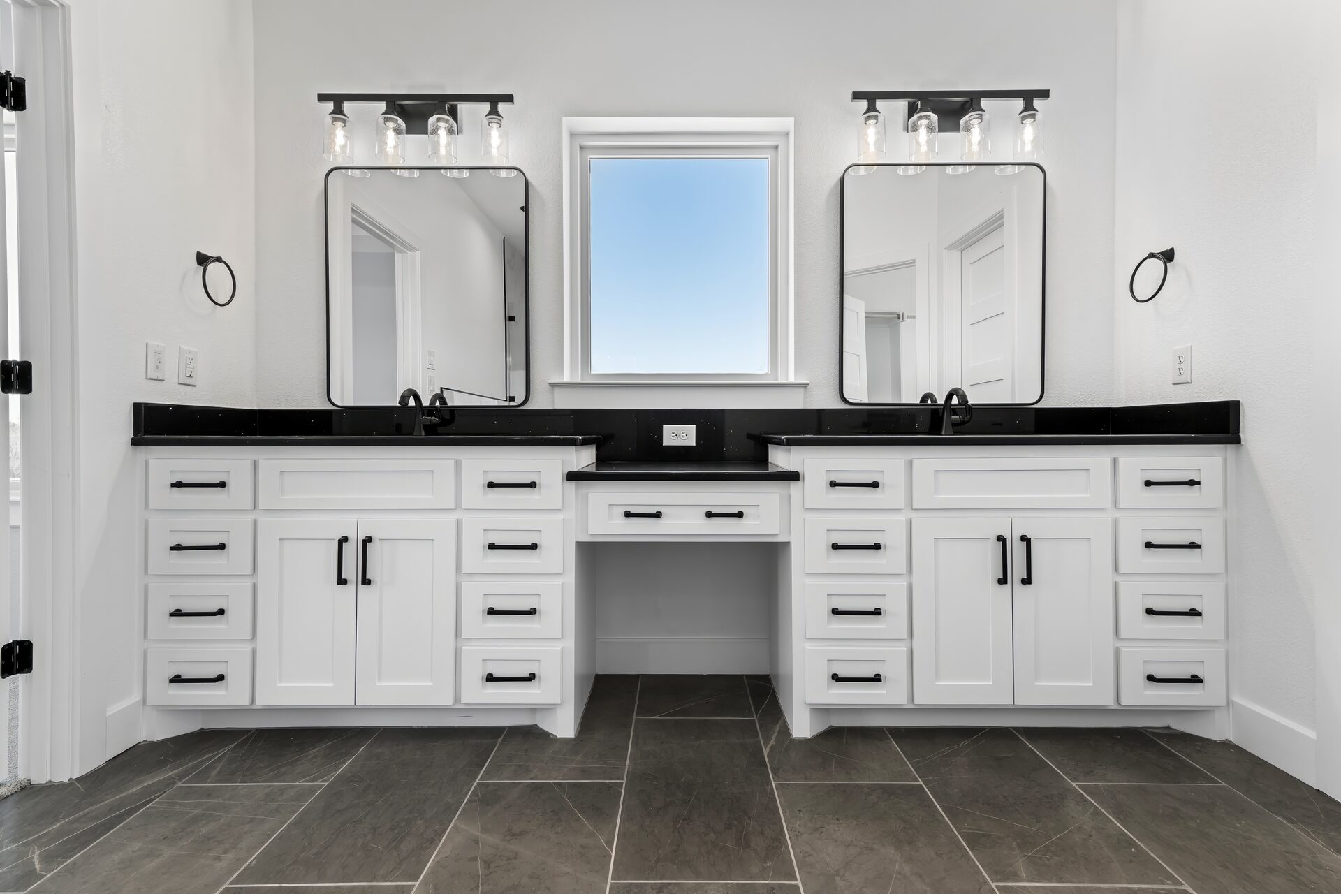 Silverado custom home master bath with dual sink vanity and black granite by RBCS Inc in North Texas