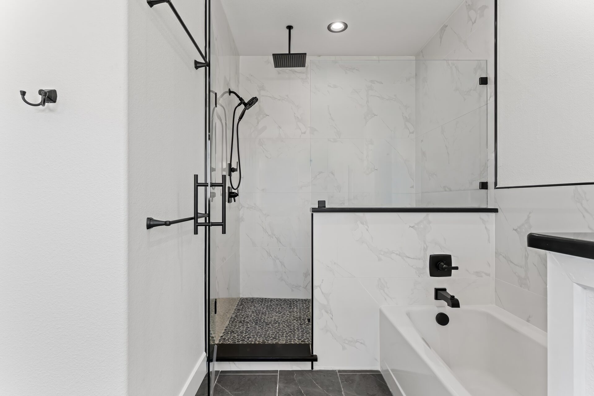 Silverado custom home master bath with marble walk-in shower and soaking tub by RBCS Inc in North Texas