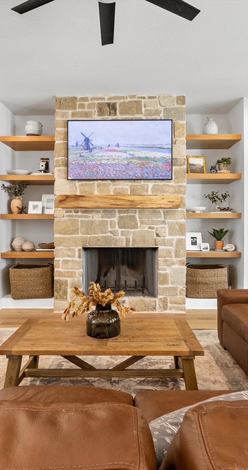 Willow custom home living room with stone fireplace and floating shelves by RBCS Inc in North Texas
